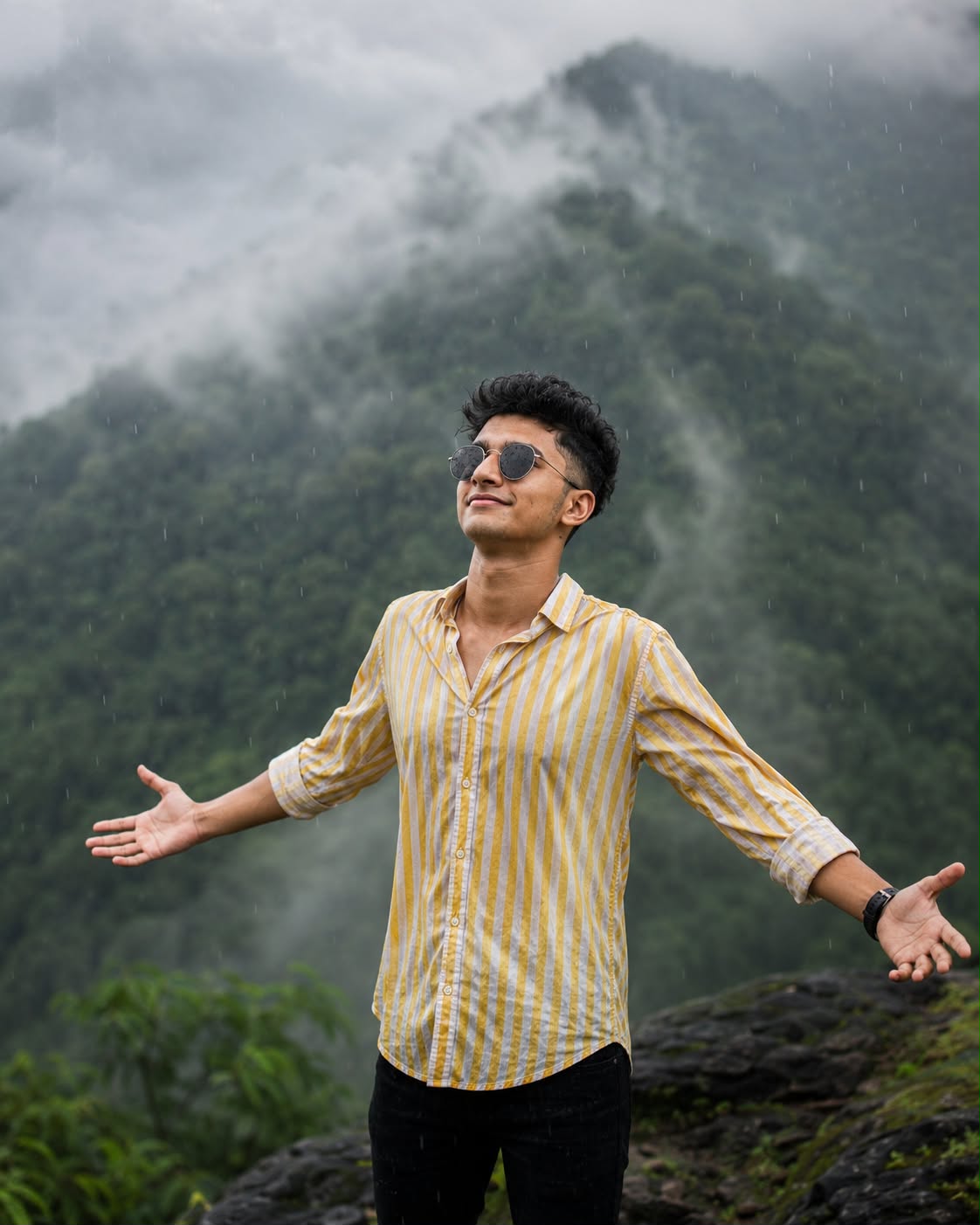 Cinematic Portrait of a Young South Asian Man in the Rain with Misty Mountains